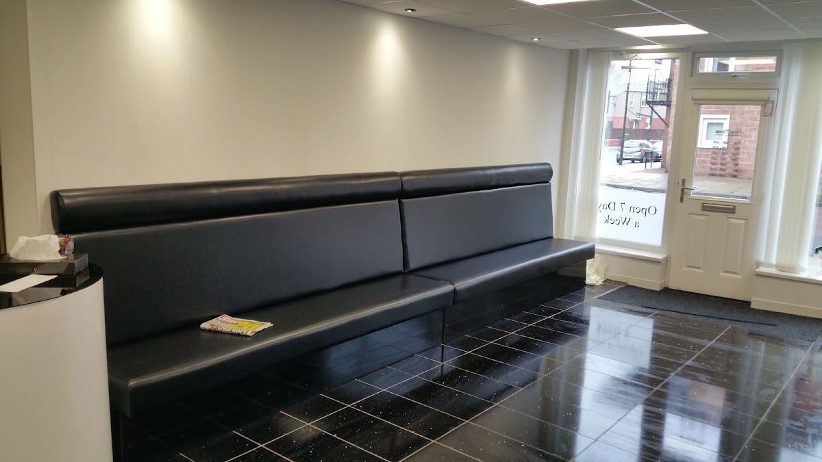 Leather waiting bench and the shopfront window